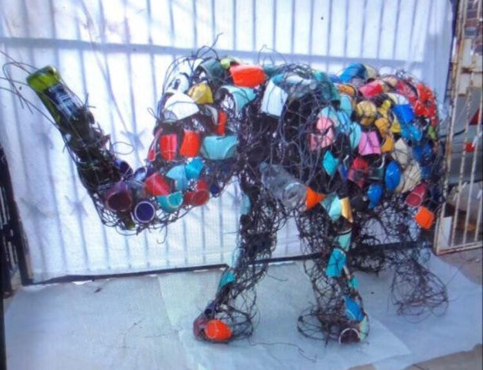 Life-size elephant covered in coloured bottle caps and plastic